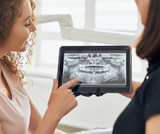 Dentist showing x-rays to a patient