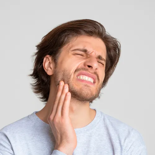 Man holding his jaw in pain.