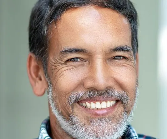 Middle aged implant patient smiling