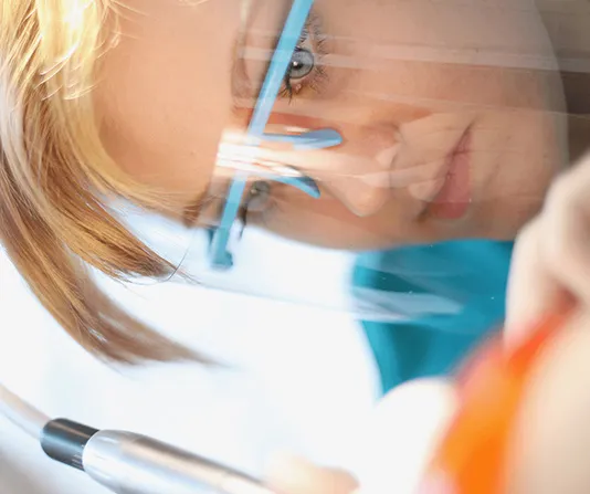 Dental hygienist works on deep cleaning for gum disease patient