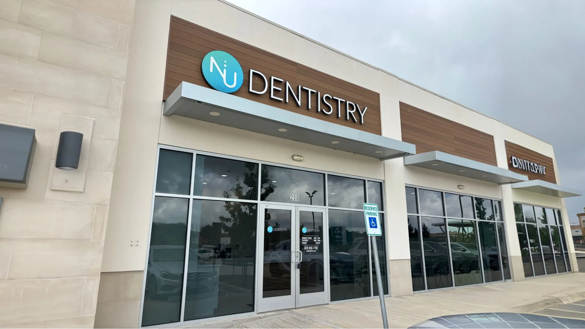 Nu Dentistry Spring exterior storefront with logo signage and glass entrance