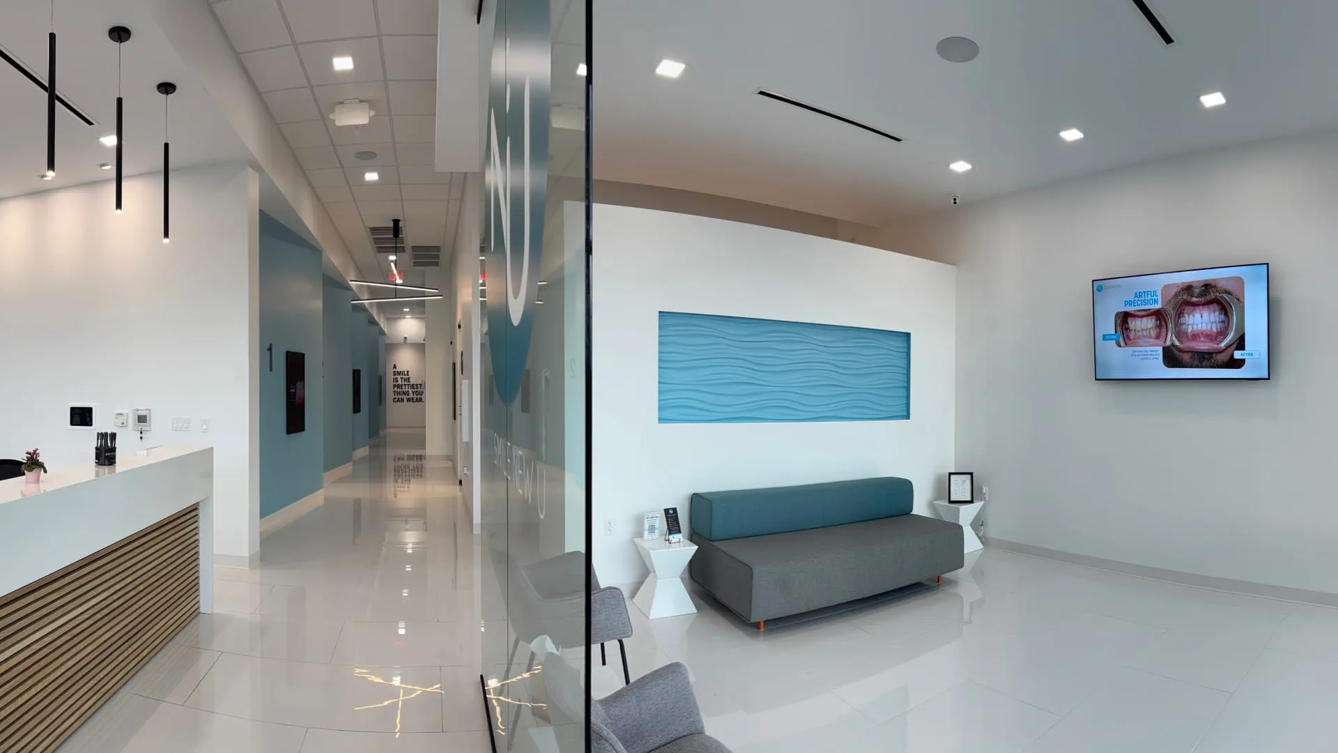 Nu Dentistry office interior showing hallway and waiting area with blue wave wall art