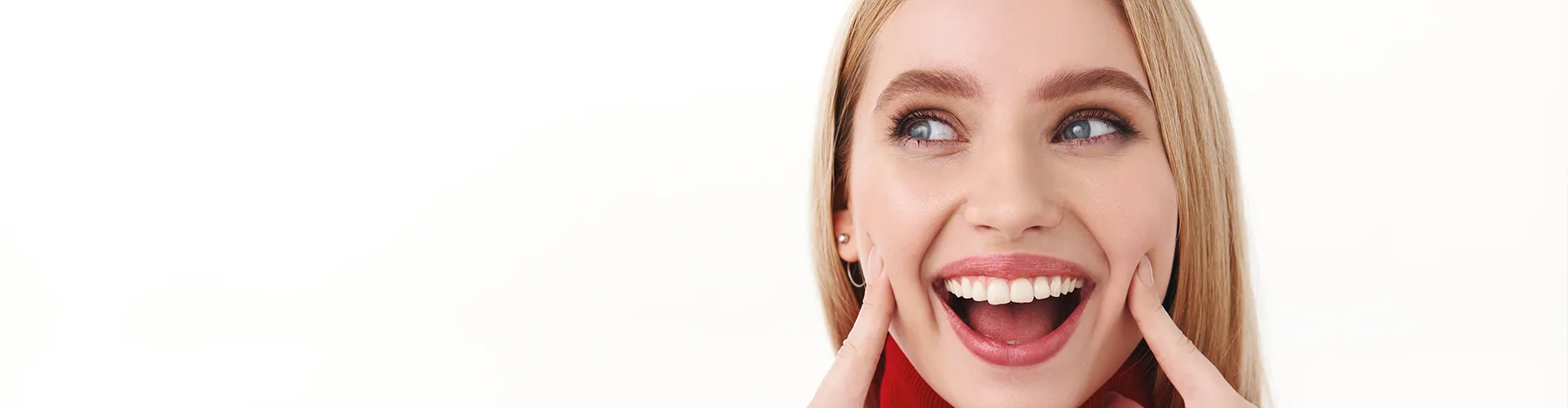 Woman pointing at her smile.