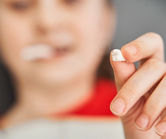 Person holding up extracted tooth
