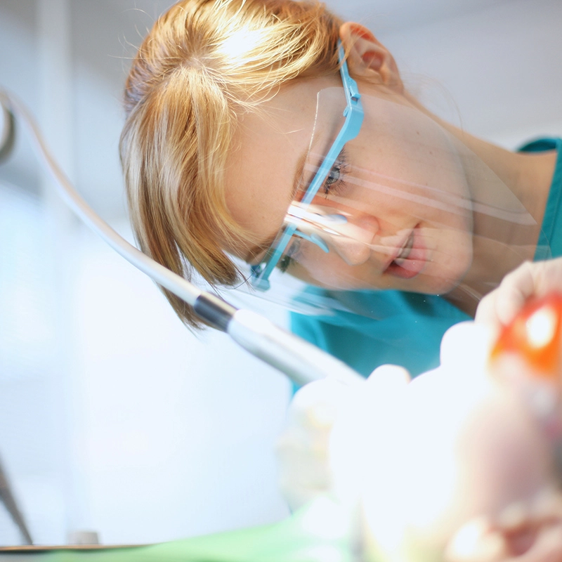 An image of a dentist performing a dental procedure