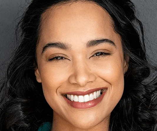 Beautiful smiling woman showing dental veneers cosmetic dentistry